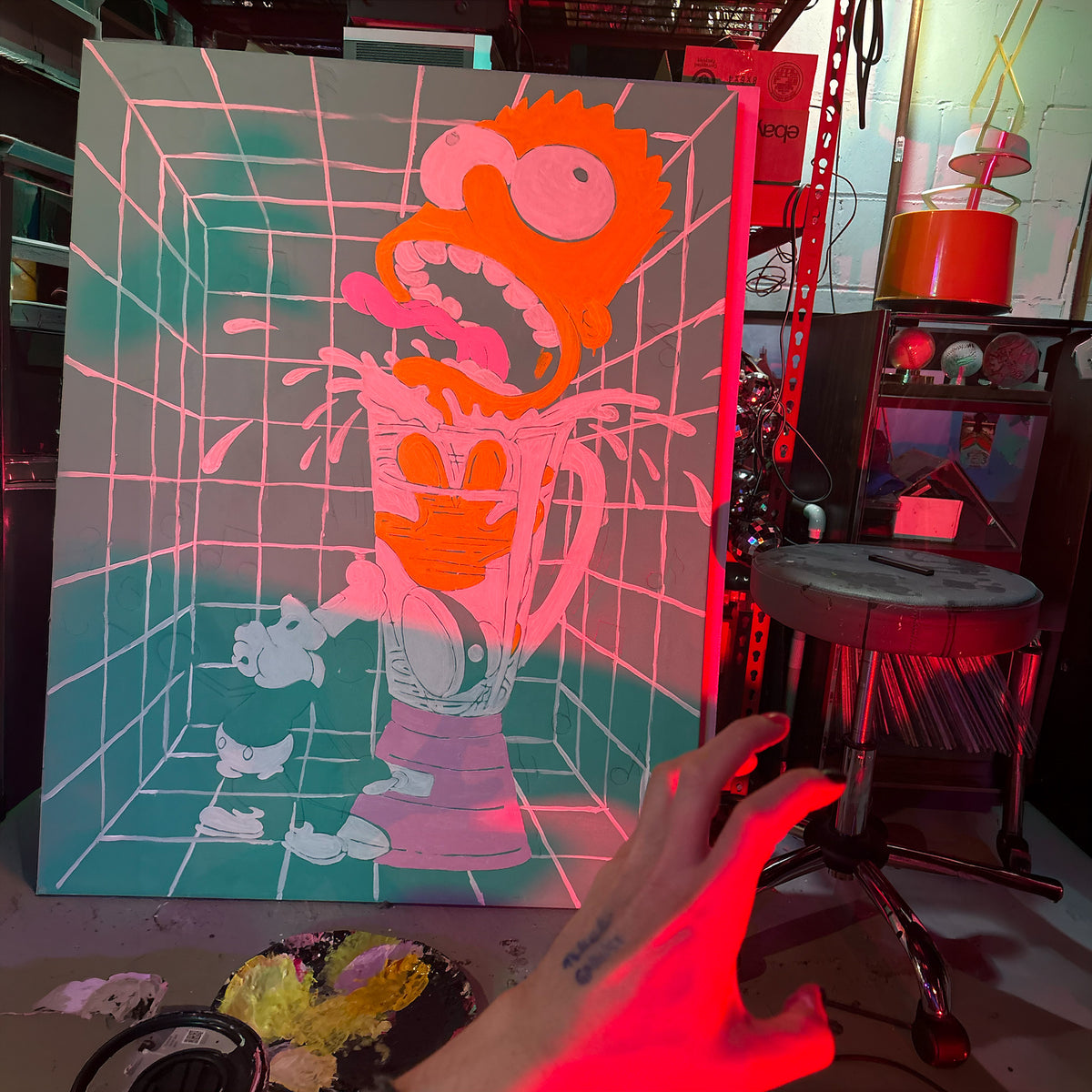 A large canvas art print featuring a stylized bart simpson classic cartoon character in an orange mask and pink striped shirt, set in a brightly lit studio with red and pink ambient lighting. A hand is visible in the foreground pointing toward the artwork by Palm Treat.